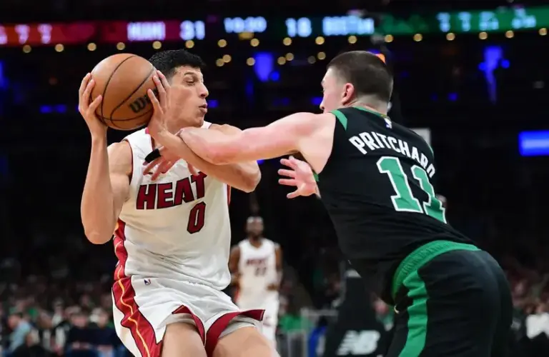Miami Heat forward Simone Fontecchio (0) is fouled by Boston Celtics guard Payton Pritchard (11) during the first half.