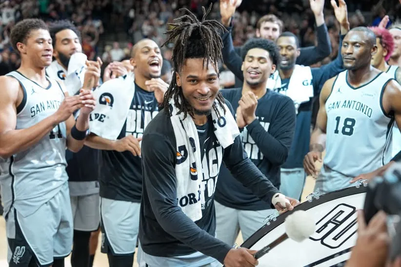 Feb 7, 2026; San Antonio, Texas, USA; San Antonio Spurs guard Stephon Castle (5) beats the drum after the game against the Dallas Mavericks at Frost Bank Center.