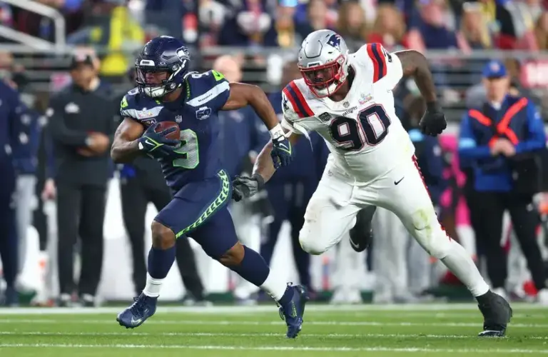 Seattle Seahawks running back Kenneth Walker III (9) runs against New England Patriots defensive tackle Christian Barmore (90) during the third quarter in Super Bowl LX at Levi's Stadium.