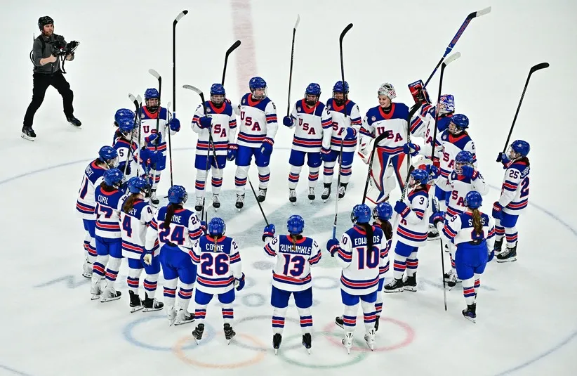February 9, 2026; Milan, Italy; United States players celebrate after defeating Switzerland in women's ice hockey group A play during the Milano Cortina 2026 Olympic Winter Games at Milano Santagiulia Ice Hockey Arena