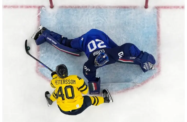 Damian Clara of Italy sprawls out to make a save against Elias Pettersson