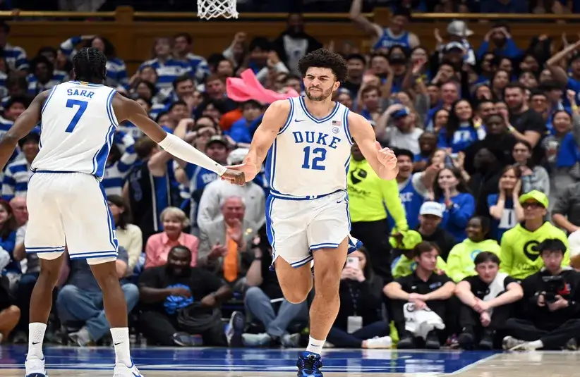 Duke Blue Devils forward Cameron Boozer (12) is greeted by forward Dame Sarr (7) after scoring a basket during the first half against the Clemson Tigers.