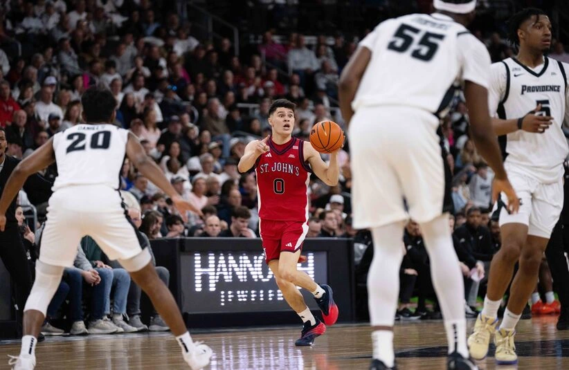 St. John's player brings ball up the court.