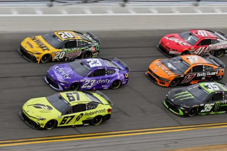 Feb 15, 2026; Daytona Beach, Florida, USA; Driver Corey Heim (67) pulls ahead of Driver Bubba Wallace (23) and Driver Christopher Bell (20) during the 68th running of the Daytona 500 at Daytona International Speedway.