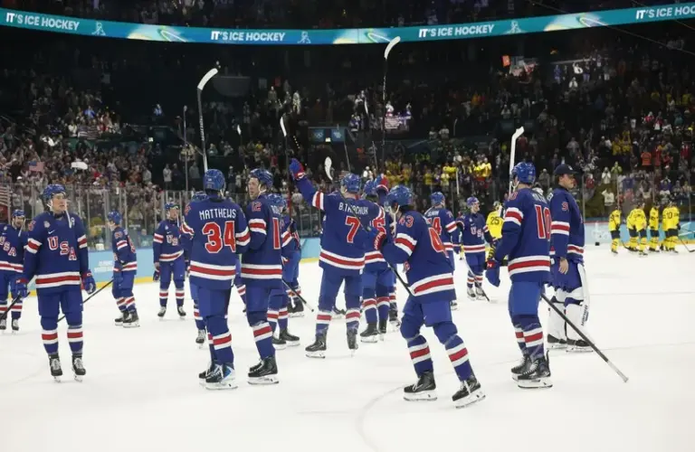 United States players celebrate after defeating Sweden in a men's ice hockey quarterfinal.