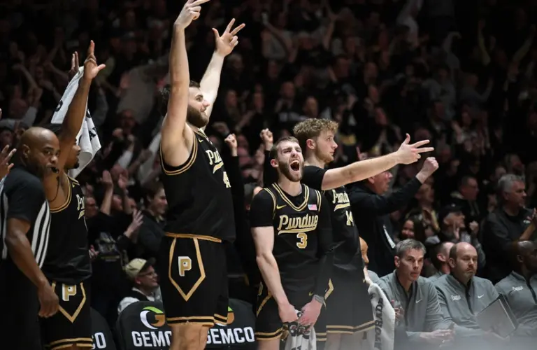 Purdue players celebrate on the bench.