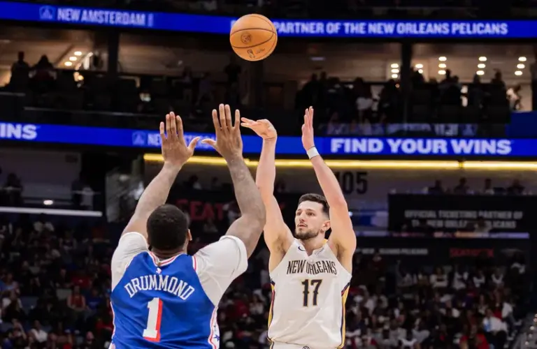 New Orleans Pelicans forward/center Karlo Matković (17) shoots a jump shot against Philadelphia 76ers center Andre Drummond (1).