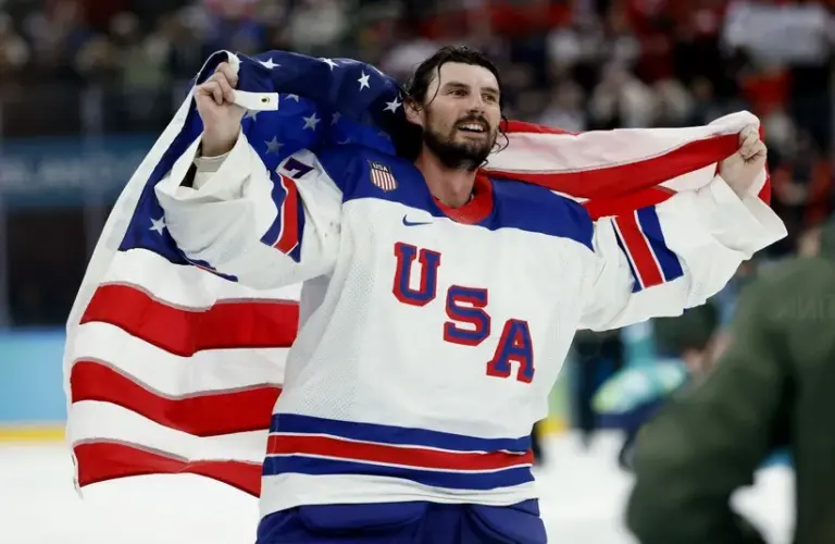 Connor Hellebuyck (37) of the United States celebrates after defeating Canada in the men's ice hockey gold medal game