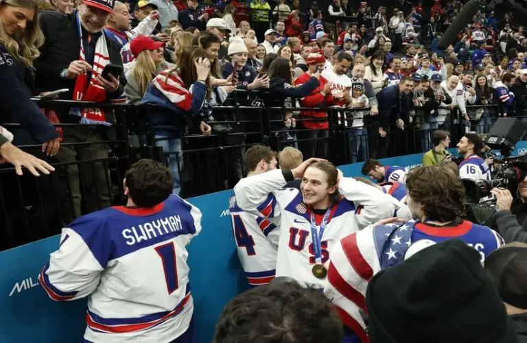 Jack Hughes (86) of Team USA celebrates with fans after defeating Canada in the men's ice hockey gold medal game