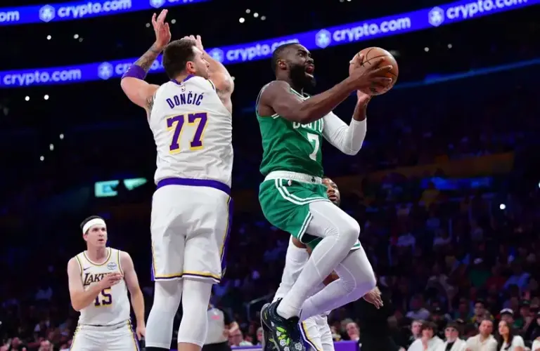 Boston Celtics guard Jaylen Brown (7) moves to the basket against Los Angeles Lakers guard Luka Doncic (77) during the first half.