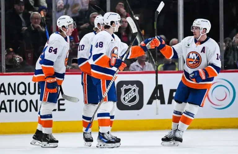 New York Islanders defenseman Matthew Schaefer (48) celebrates with his teammates his first goal of the game against the Montreal Canadiens