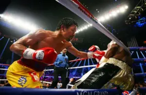 ; Manny Pacquiao (left) punches Floyd Mayweather against the ropes during their boxing bout at the MGM Grand Garden Arena