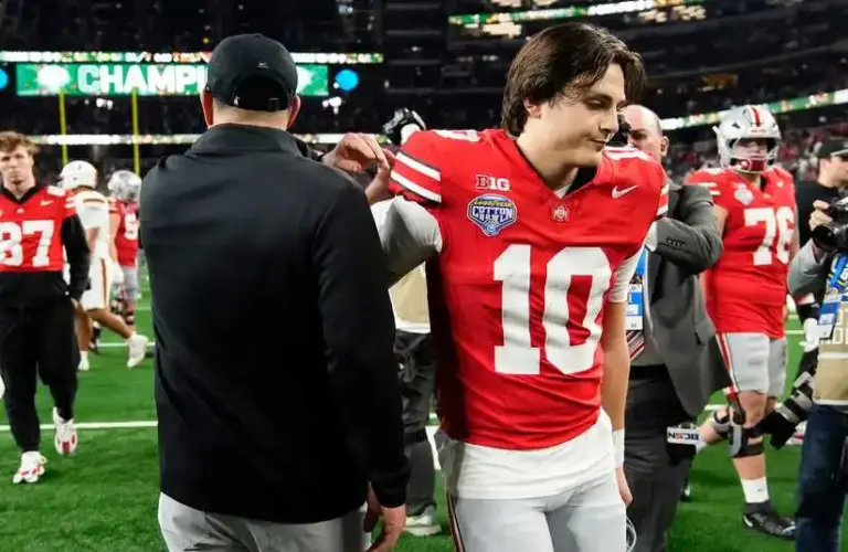 Ohio State Buckeyes quarterback Julian Sayin (10) hugs head coach Ryan Day following the Cotton Bowl at AT&T Stadium in Arlington, Texas for the College Football Playoff quarterfinal game on Dec. 31, 2025. Ohio State lost 24-14.