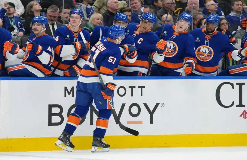 Mar 17, 2026; Toronto, Ontario, CAN; New York Islanders left wing Emil Heineman (51) celebrates at the bench after scoring a goal against the Toronto Maple Leafs during the second period at Scotiabank Arena.