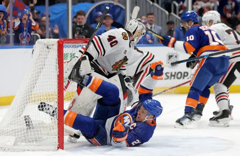 Mar 24, 2026; Elmont, New York, USA; New York Islanders left wing Anders Lee (27) slides into Chicago Blackhawks goaltender Arvid Soderblom (40) after being tripped by Blackhawks center Ryan Donato (not pictured) during the third period at UBS Arena.