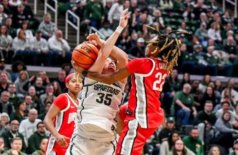 Michigan State's Kennedy Blair, left, is fouled by Ohio State's Jaloni Cambridge while shooting during the fourth quarter on Sunday, March 1, 2026, at the Breslin Center in East Lansing.