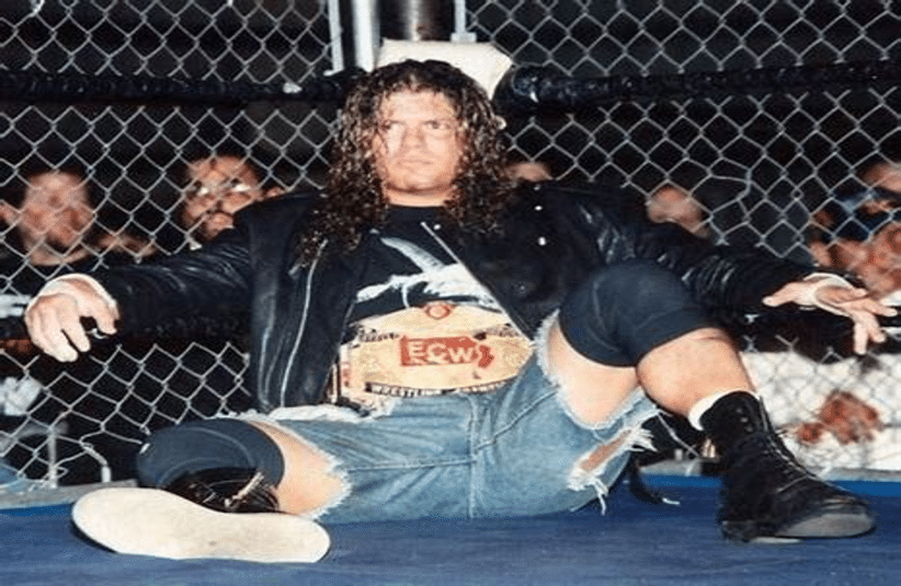 Raven Sitting In the corner of ECW Ring with ECW championship