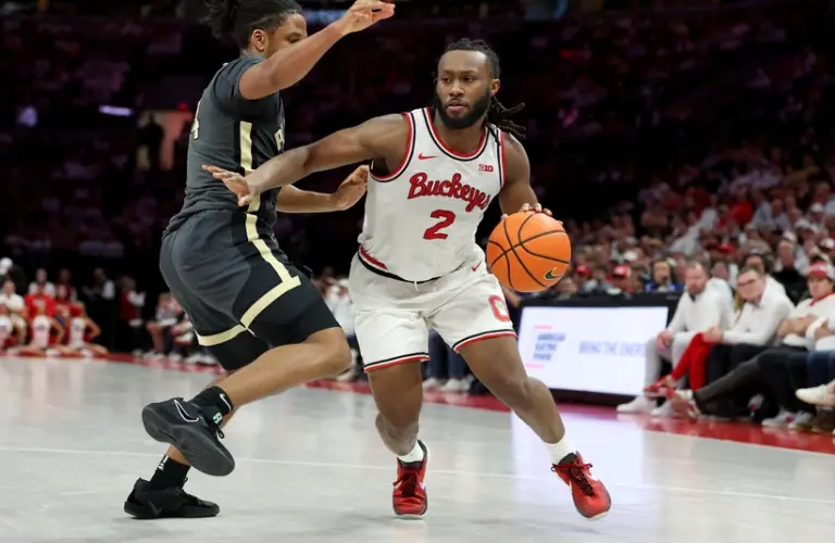 Mar 1, 2026; Columbus, Ohio, USA; Ohio State Buckeyes guard Bruce Thornton (2) controls the ball as Purdue Boilermakers guard Gicarri Harris (24) defends during the second half at Value City Arena.