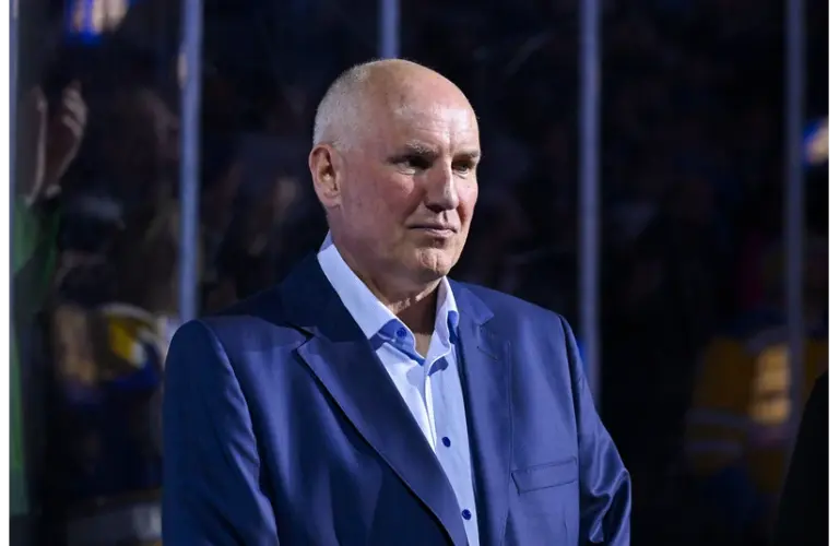 Doug Armstrong standing at a game