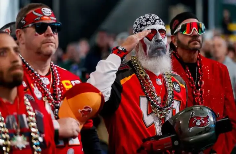 Tampa Bay Buccaneers fan salutes during the playing of the national anthem before the first round of the 2025 NFL Draft