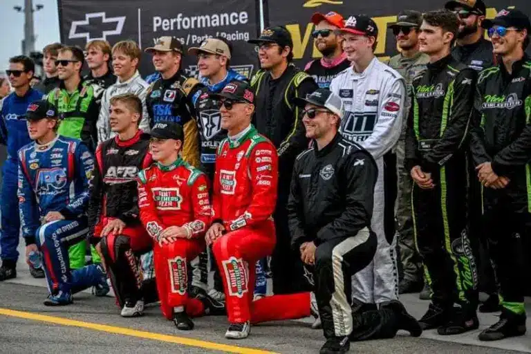 Former NASCAR Cup Series champion Kevin Harvick, center, and his 13-year-old son Keelan, left, pose with other drivers before the 13th annual Masters of the Pros 200 race on Wednesday, July 16, 2025, at the Owosso Speedway.