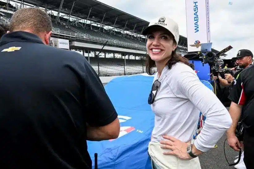 NASCAR Xfinity Series driver Katherine Legge (32) stands by her car Saturday, July 26, 2025, during qualifying for the Pennzoil 250 at Indianapolis Motor Speedway.