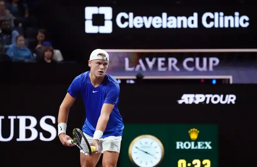 Rune hitting a serve