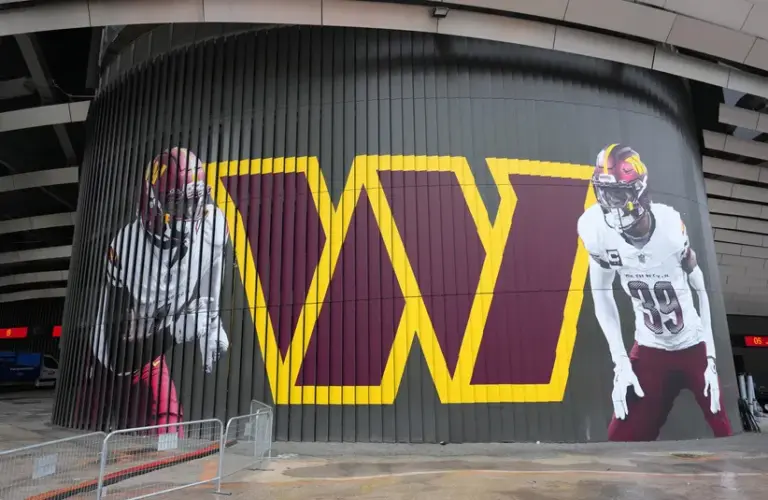 Washington Commanders Logo and receiver Deebo Samuel and safety Jeremy Reaves at Bernabeu Stadium Madrid Spain Game