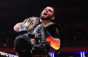 Islam Makhachev (blue gloves) celebrates after defeating Jack Della Maddalena