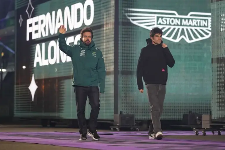 Nov 22, 2025; Las Vegas, NV, USA; Aston Martin Racing driver Fernando Alonso (14), left, and Aston Martin Racing driver Lance Stroll (18) arrive for the Las Vegas Grand Prix drivers parade at the Las Vegas Strip Circuit.