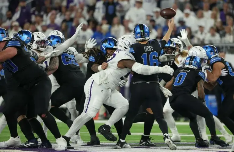 Minnesota Vikings defensive tackle Javon Hargrave (97) tackles Detroit Lions quarterback Jared Goff (16)
