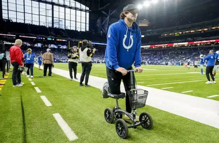 Indianapolis Colts quarterback Daniel Jones moves along the sideline on a scooter