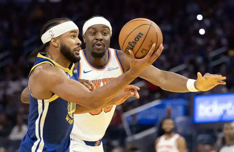 Golden State Warriors guard Moses Moody (4) drives to the basket defended by New York Knicks center Ariel Hukporti (55)
