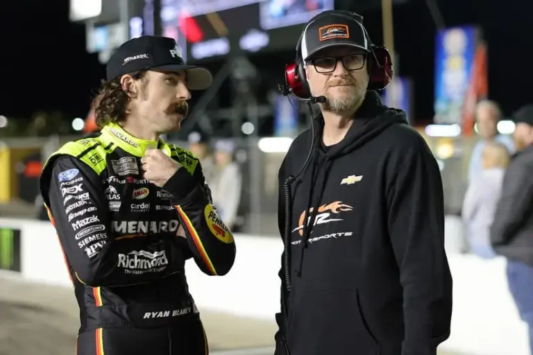 Junior; Feb 11, 2026; Daytona Beach, Florida, USA; NASCAR Cup Series driver Ryan Blaney (12) talks with former driver Dale Earnhardt Jr. during qualifying for the Daytona 500 at Daytona International Speedway.