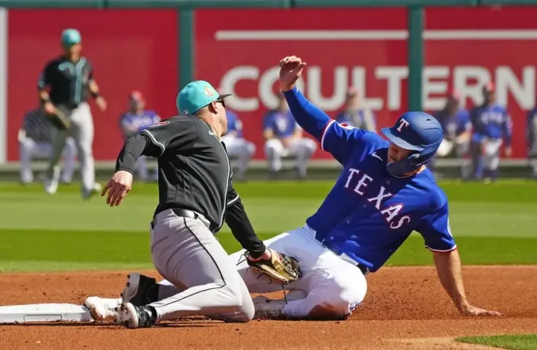 Rangers outfielder Wyatt Langford (61) slides safely into second base