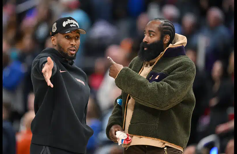Cleveland Cavaliers guard Donovan Mitchell (left) talks with teammate James Harden during a timeout against the Detroit Pistons in the second half at Little Caesars Arena.