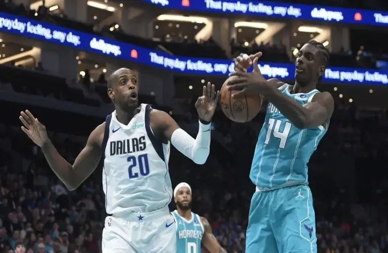 Dallas Mavericks forward Khris Middleton (20) and Charlotte Hornets forward center Moussa Diabate (14) fight for a rebound