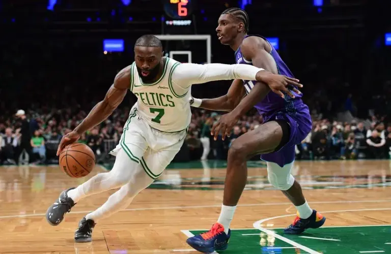 Boston Celtics guard Jaylen Brown (7) controls the ball while Charlotte Hornets forward Moussa Diabate (14) defends