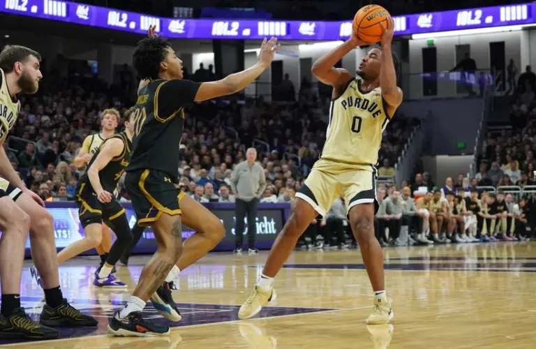 Purdue guard CJ Cox puts a shot up against Northwestern.