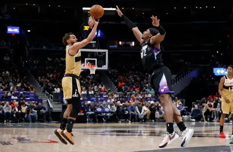 Washington Wizards guard Trae Young (3) shoots the ball as Utah Jazz forward Blake Hinson (2) defends in the first half.