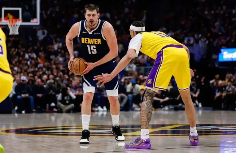 Denver Nuggets center Nikola Jokic (15) controls the ball as Los Angeles Lakers center Jaxson Hayes (11) guards in the first quarter.
