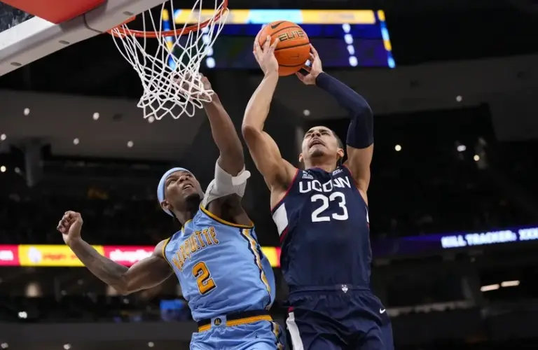 UConn forward Jayden Ross (23) shoots against Marquette Golden Eagles guard Chase Ross (2)