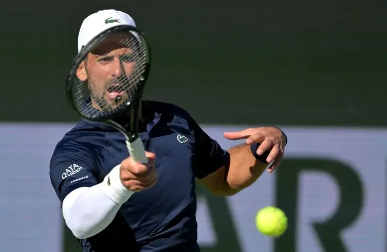 Novak Djokovic (SRB) hits a shot during his second round match