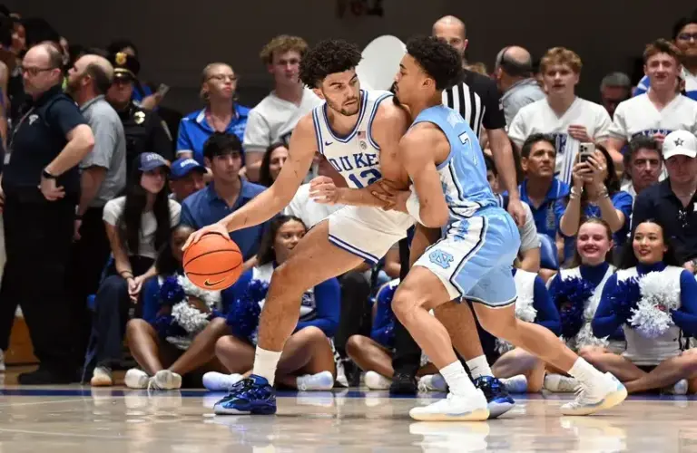 Duke Blue Devils forward Cameron Boozer (12) controls the ball in front of North Carolina Tar Heels guard Seth Trimble (7) during the first half.