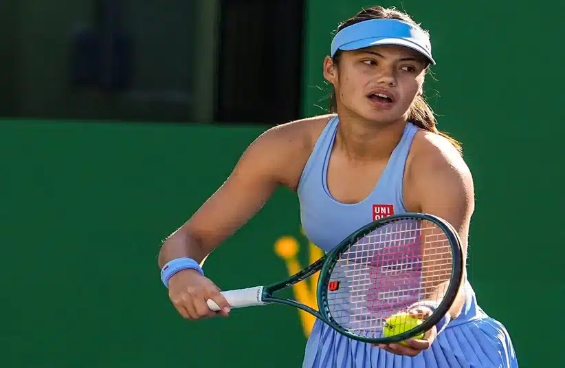 Raducanu preparing a serve