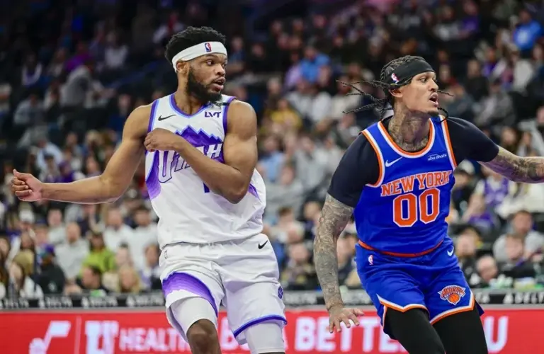Utah Jazz guard Elijah Harkless (16) and New York Knicks guard Jordan Clarkson (00) react to a rebound