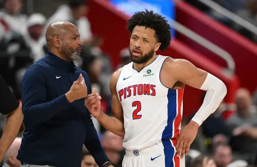 Detroit Pistons head coach J.B. Bickerstaff talks with Pistons guard Cade Cunningham (2)