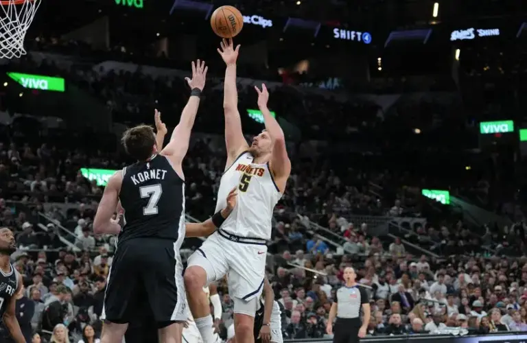 Denver Nuggets center Nikola Jokic (15) shoots over San Antonio Spurs center Luke Kornet (7) in the first half.