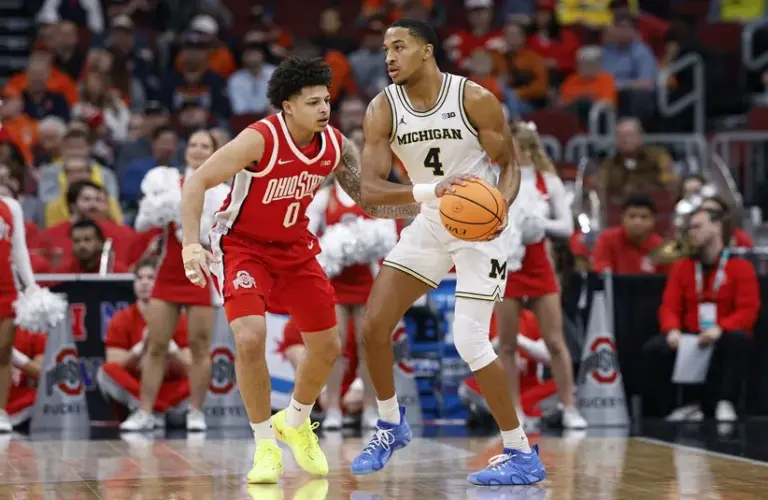 Ohio State Buckeyes guard John Mobley Jr. (0) defends against Michigan Wolverines guard Nimari Burnett (4)