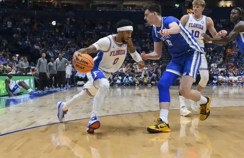 Florida Gators guard Boogie Fland (0) drives baseline